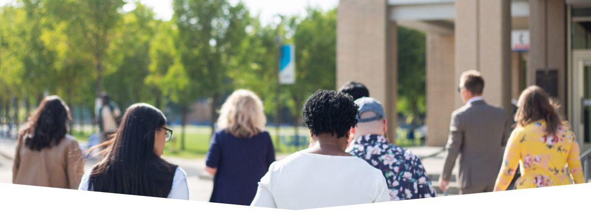 Members of the Alumni Council walking through the East Gate lawn.