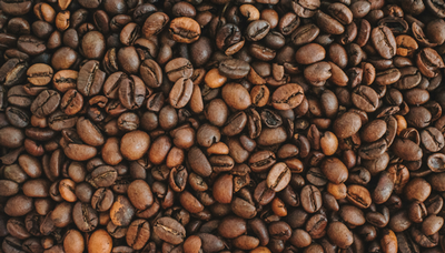 Roasted, unground coffee beans.