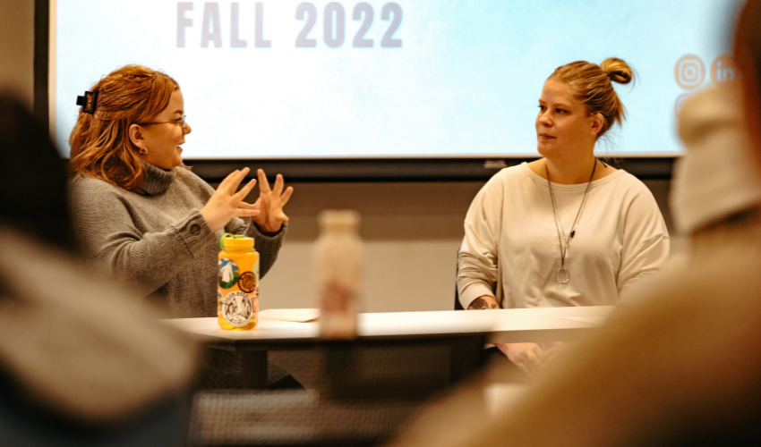 Close up of two people in a panel discussion