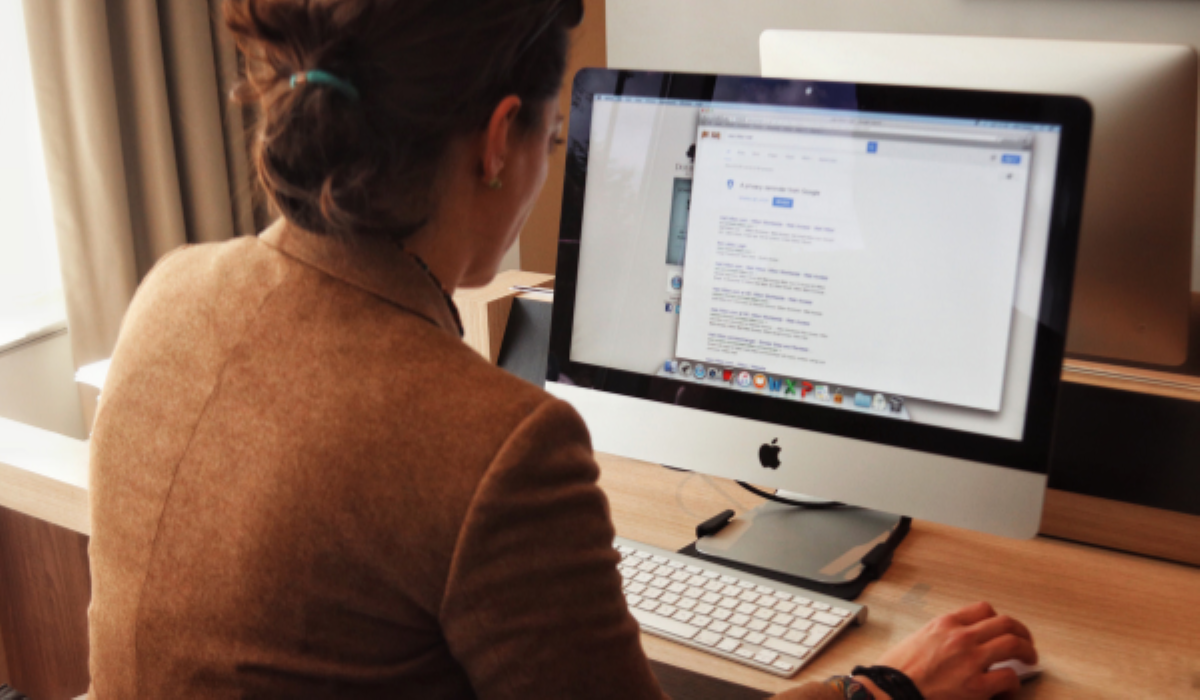 A woman working on a computer at a desk