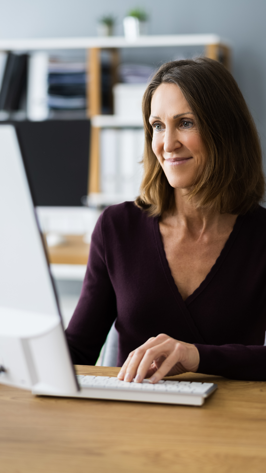 A person working in a home office on their computer.
