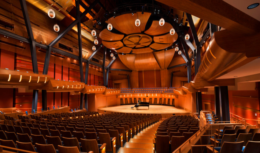The warm wood interior of the Bella Concert Hall featuring the acoustic rosette