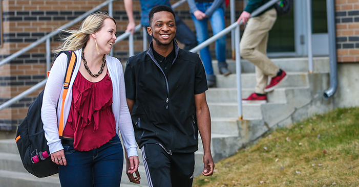 Two students outside West Residence