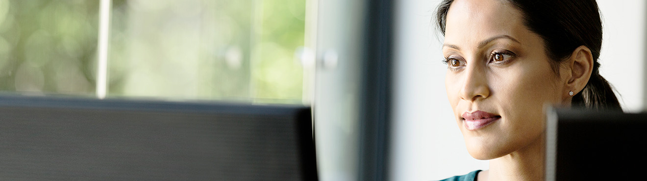 A woman looking at a computer screen.