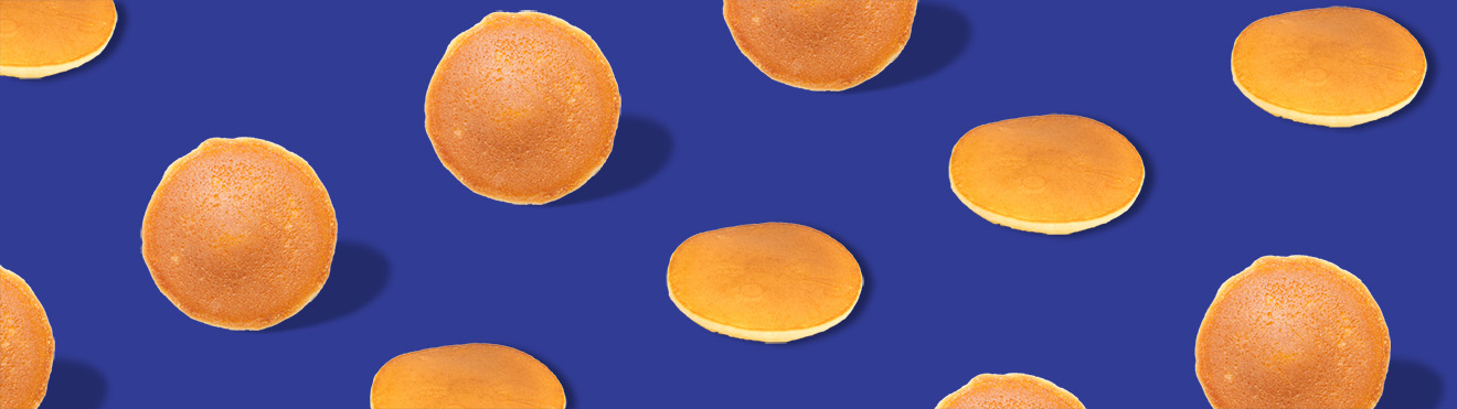 Pancakes in a pattern on a royal blue background.