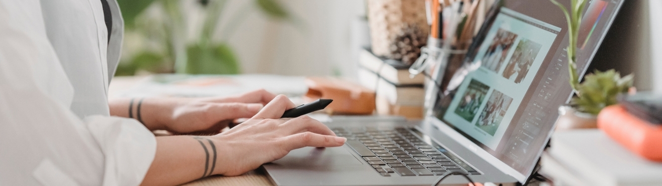 Photo of hand typing on the keyboard of a laptop.