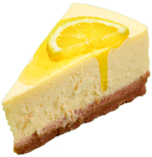 A slice of cheesecake with a lemon slice and drizzle.
