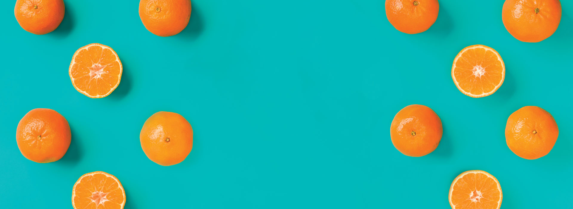 A pattern of oranges on a teal background.