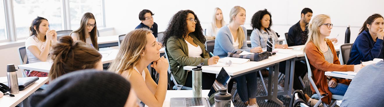 A group of students listening to a lecture in a Mount Royal classroom.