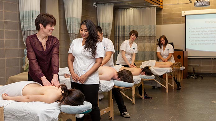 An instructor teaching a student in the Mount Royal Massage Therapy clinic.