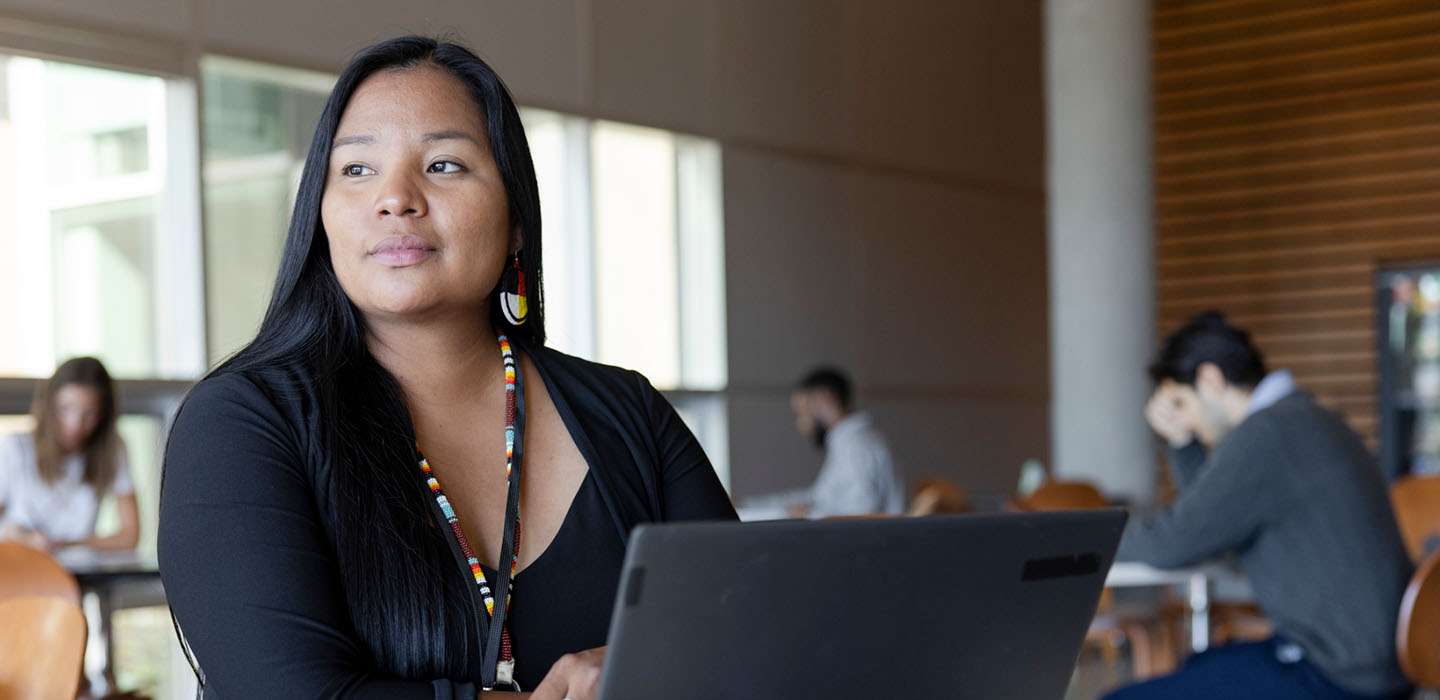 A woman working at a laptop in Mount Royal University's Roderick Mah Centre for Continuous Learning.