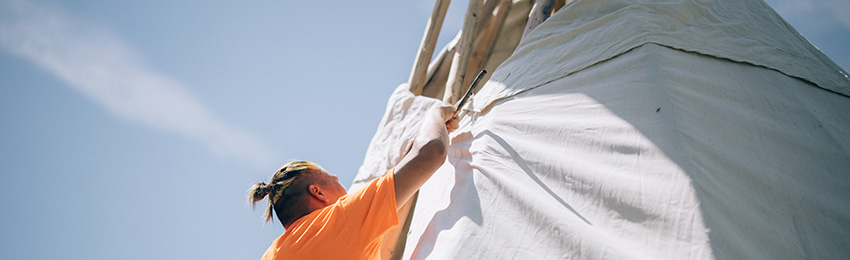Man raising a tipi