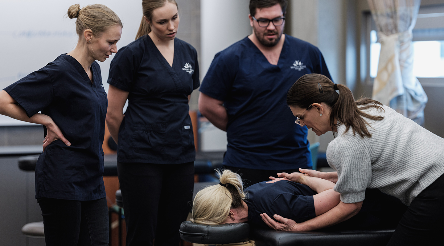 A group of Mount Royal massage therapy students performing massages as part of their hands-on training.
