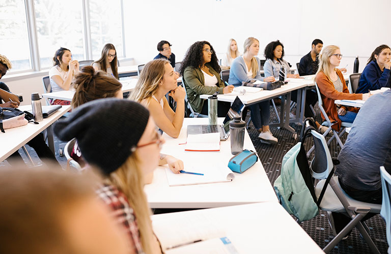 A group of students listening to a lecture in a Mount Royal classroom.