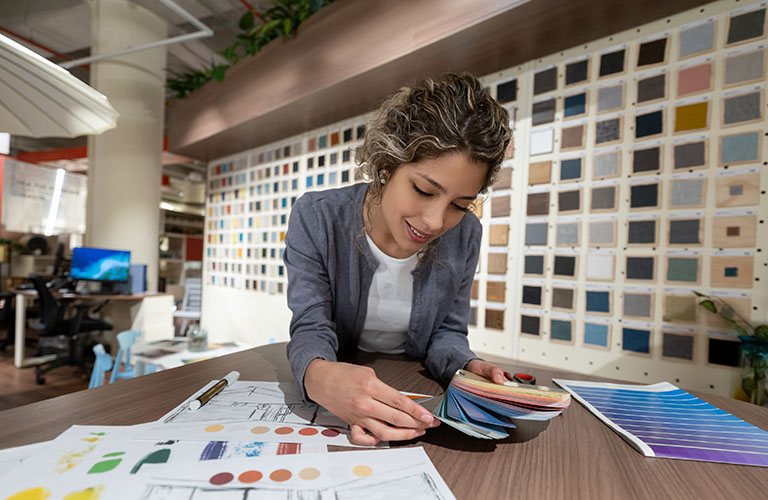 Interior decorator reviewing colour swatches in an office