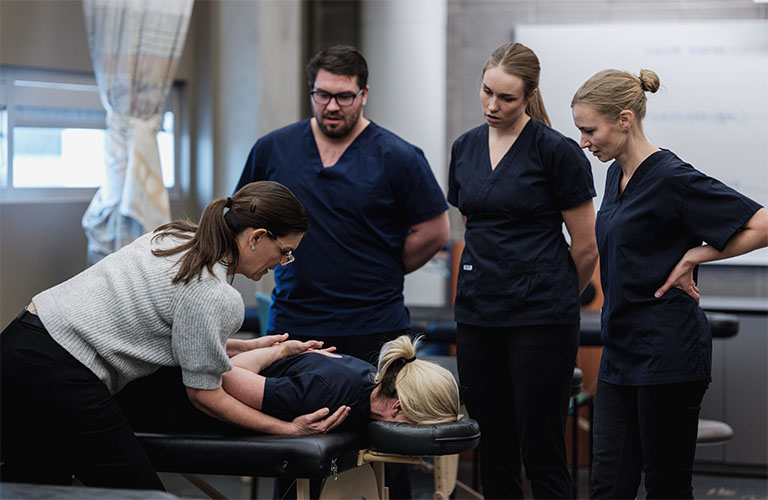 A group of Mount Royal massage therapy students performing massages as part of their hands-on training.