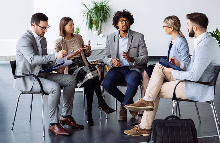 A group of professionals having a round table discussion.