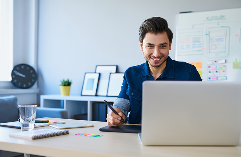 A man working at a laptop.