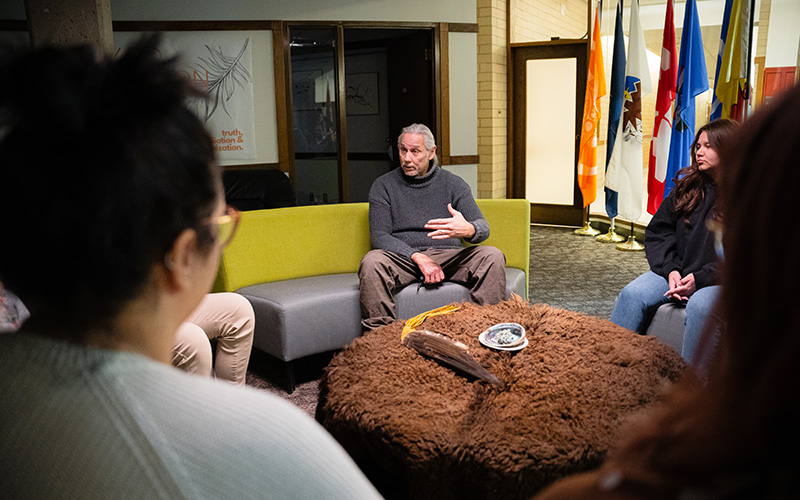 Iniskim staff and students at a smudge ceremony in the Iniskim Centre.