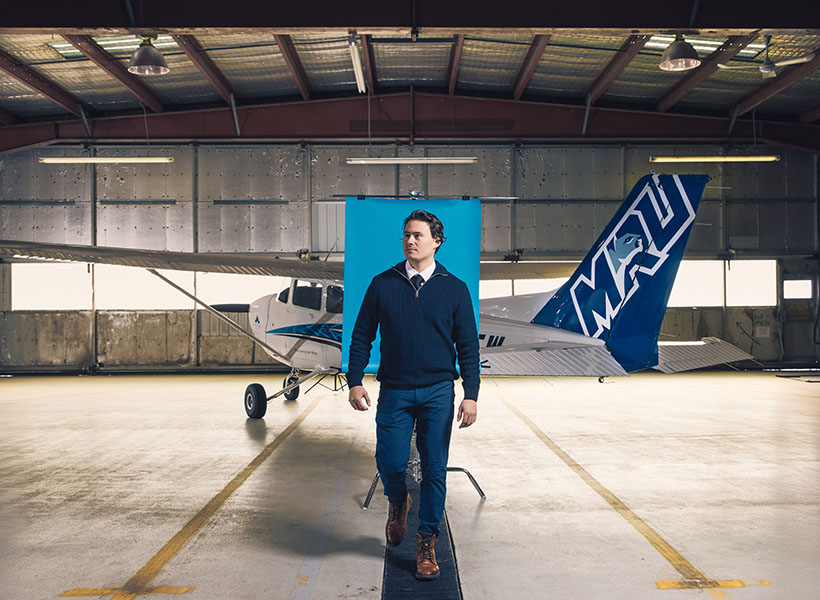 Sid Nichol stands in front of an airplane at the Mount Royal University Springbank Campus.