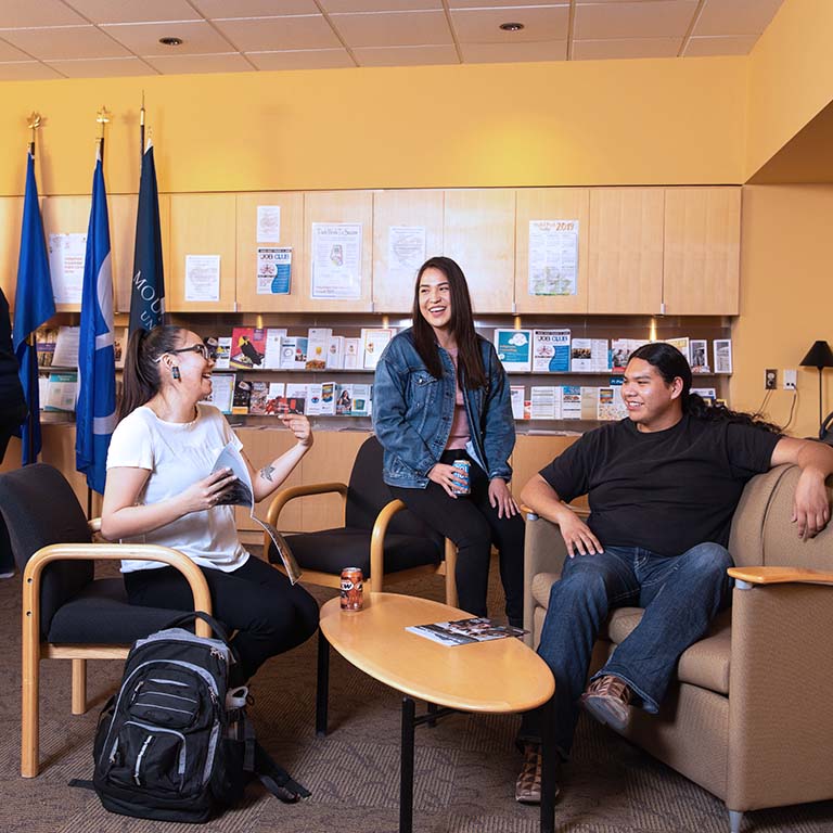 Three students chatting in the Iniskim Centre