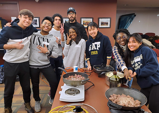 Students at an intercultural potluck in the Global Student Lounge.