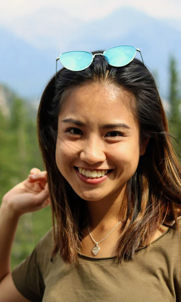 International student Trinh Dong poses in front of the Rocky Mountains