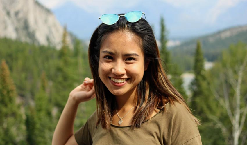 International student Trinh Dong poses in front of the Rocky Mountrains