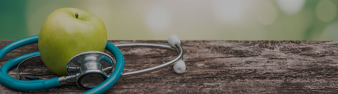 An apple wrapped up in a stethoscope.