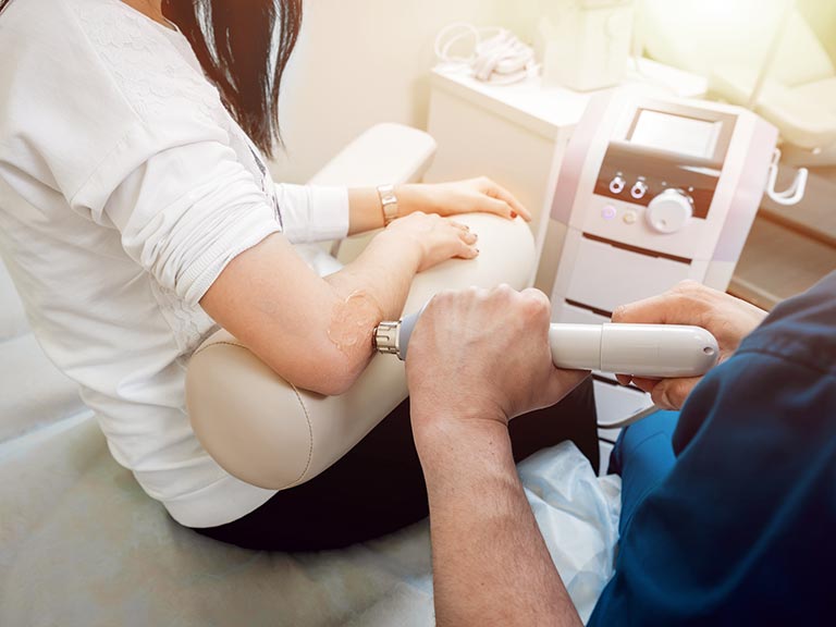 Photo of a person recieving shock wave therapy