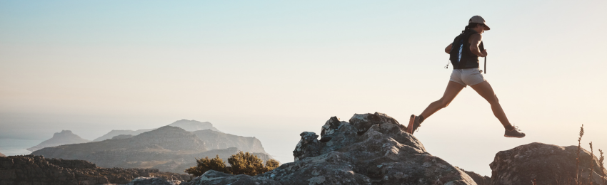 Woman climbing mountain tops