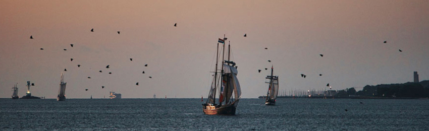 Photo of ships sailing on a harbour.