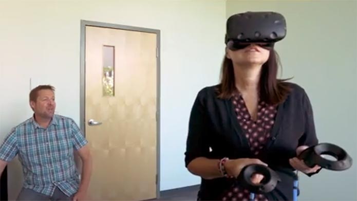 A researcher supervises a person using a VR headset while in the Centre for Psychological Innovation.