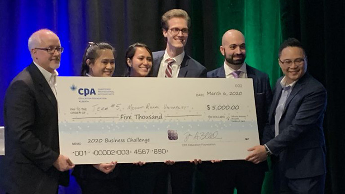 Mount Royal's CPA Business Challenge case team, made of Accounting students Ben Barfuss, Martin Keskin, Chantelle Linares, and Linda Tran, holding a notvelty cheque worth $5000
