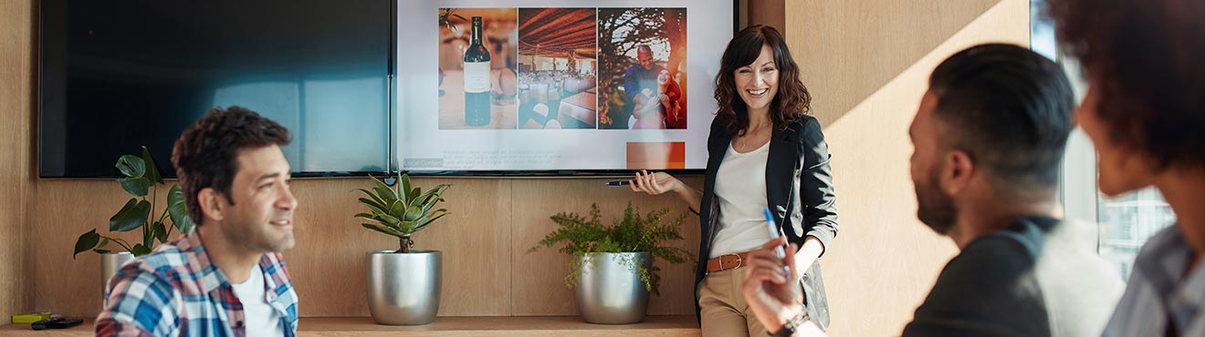 Young professional presents to a room full of other professionals.