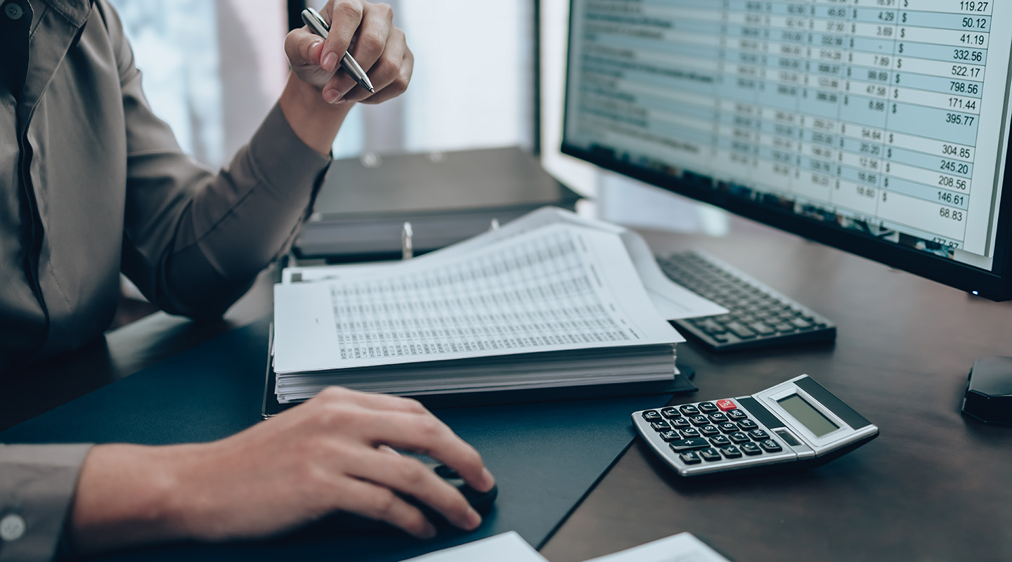 A person reviewing a spreadsheet of figures.