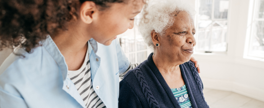 Young black women is walking with an older adult black women while showing support.