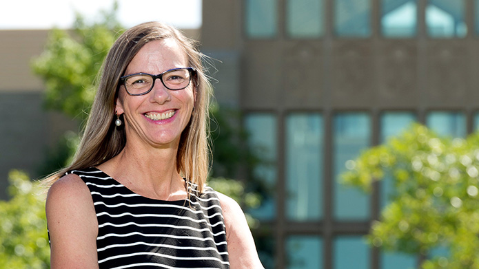 Dr. Van Den Kerkhof, PhD, in front of Mount Royal University