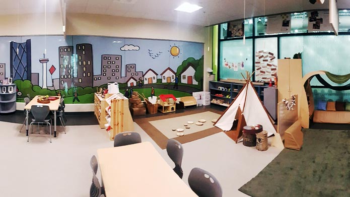 A view of the Child Development Lab showcasing the child tipi and a mural of Calgary's downtown.