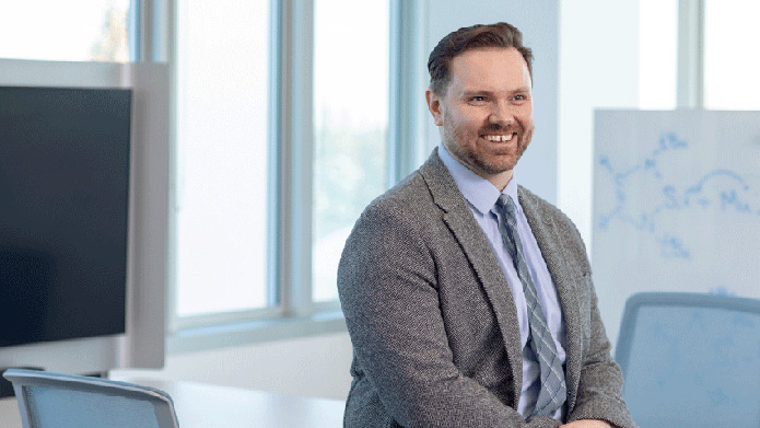 Professor Brett McCollum, PhD, in an Active Learning Classroom at Mount Royal's Riddell Library and Learning Centre.