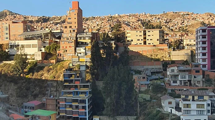 A panoramic photo of mountains surrounding a village in El Alto near La Paz, Bolivia.