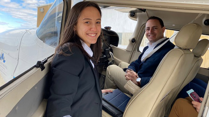 Aviation student Alissa Stirling prepares to take Minister for Advanced Education Demetrios Nicolaides for a flight.