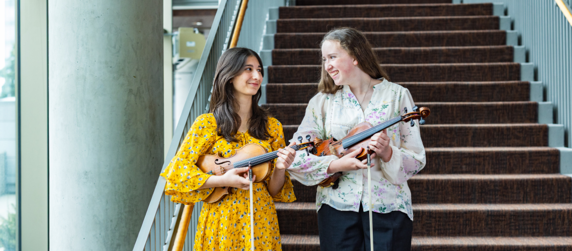 Girls holding the violin
