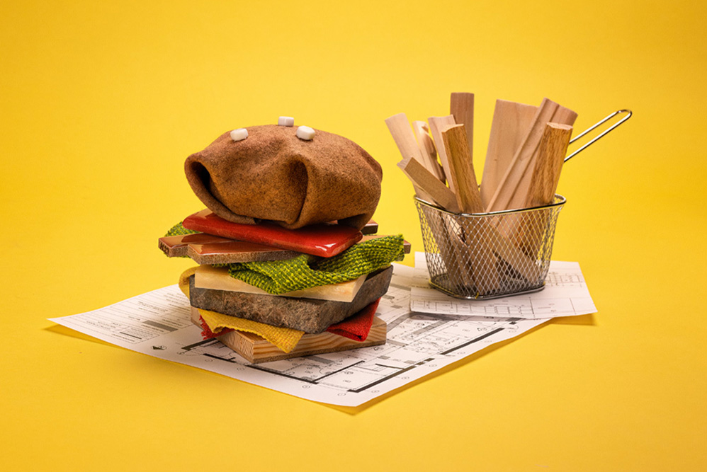 A burger made out of textiles on a yellow background.