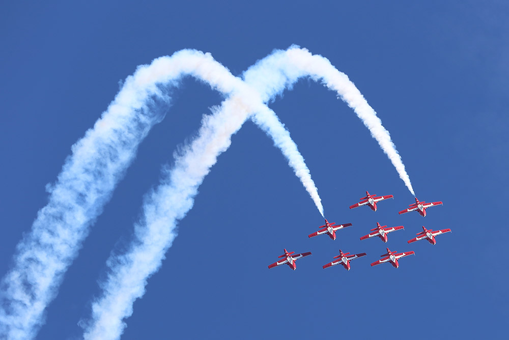 A formation of planes from Canada's Snowbirds pull an aerial maneuver.