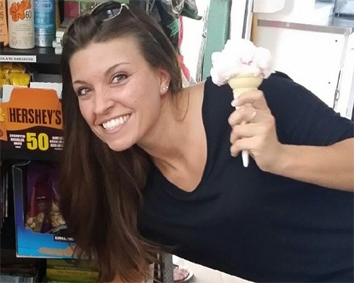 Julia Wenzel grins broadly as she poses with an ice cream cone.