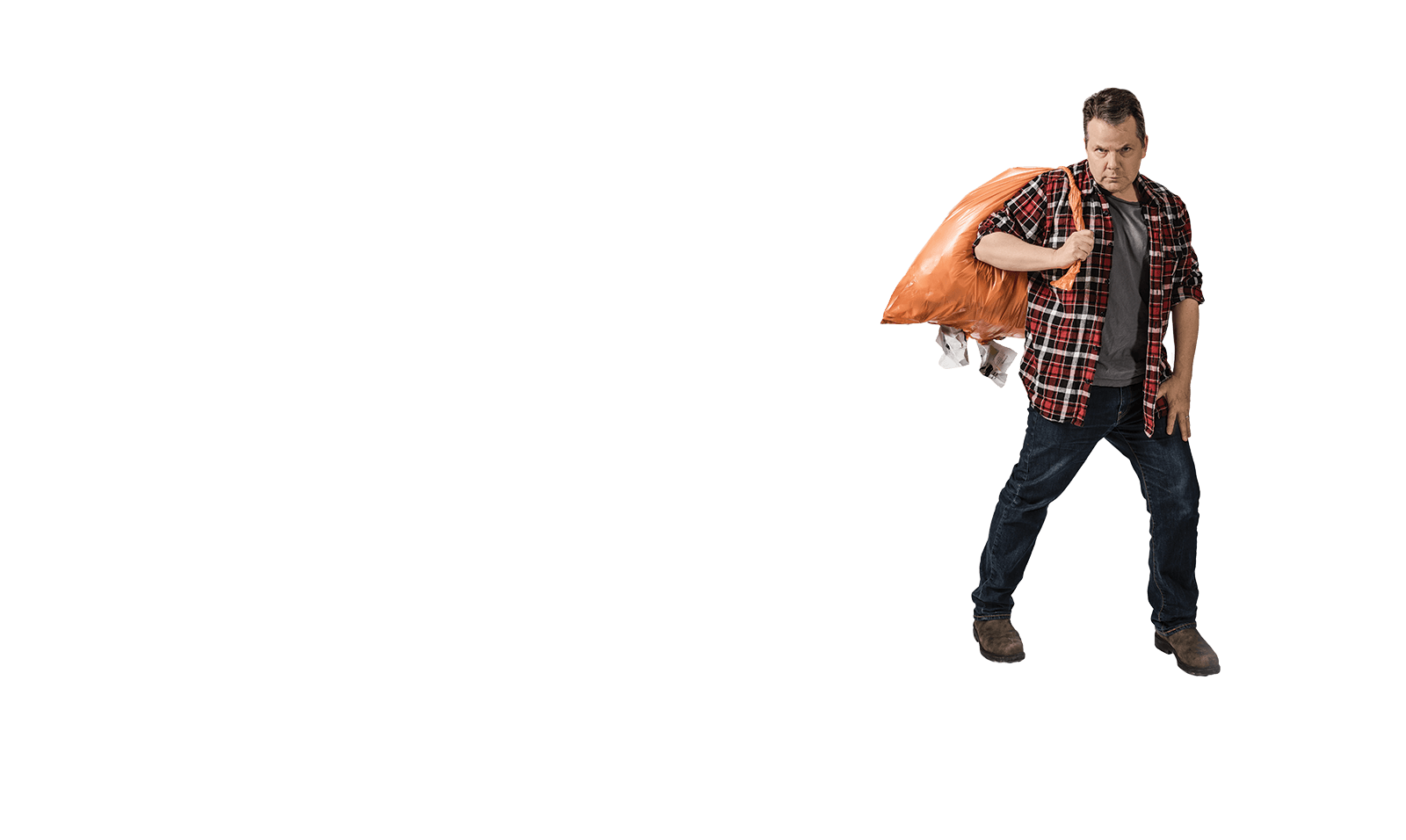 Photo of Bruce McCulloch walking holding a garbage bag. A variety of school products are strewn behind him.