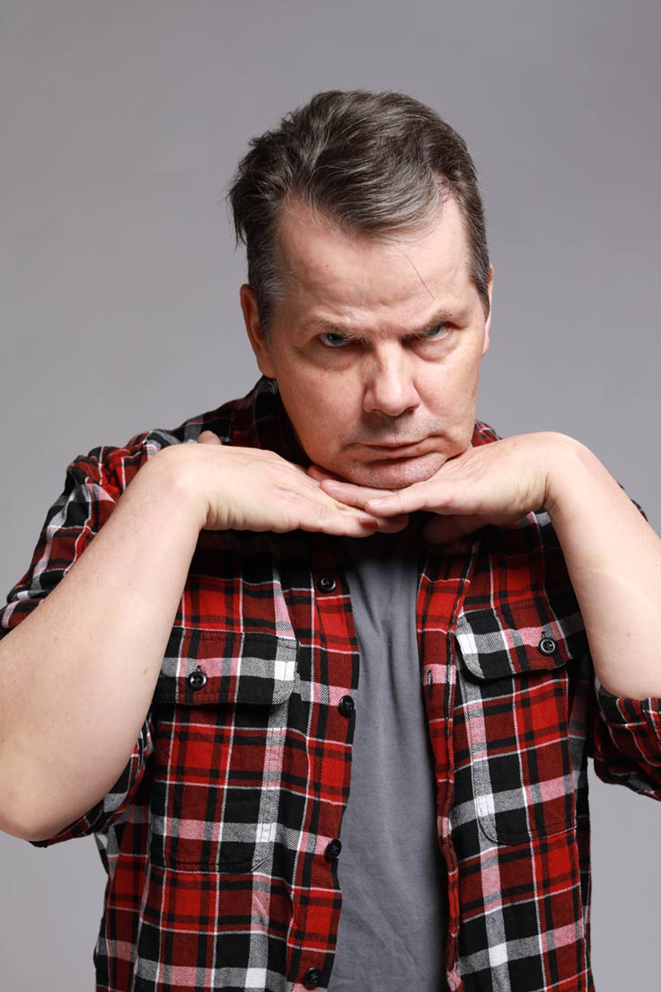 Photo of Bruce McCulloch resting his chin on his hands, which are held flat as if on a table.