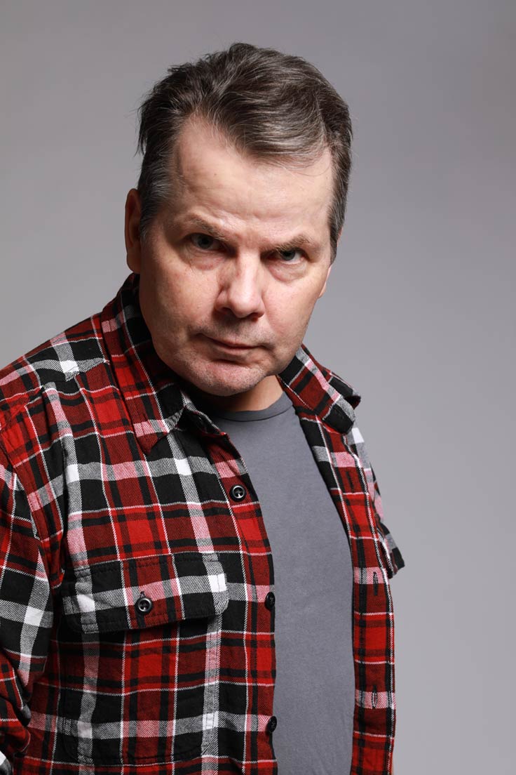 Photo of Bruce McCulloch staring intently into the camera.