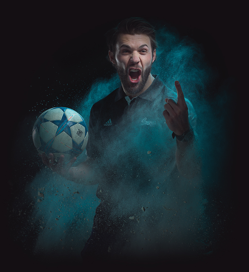Photo of Ryan Gyaki holding a soccer ball while yelling